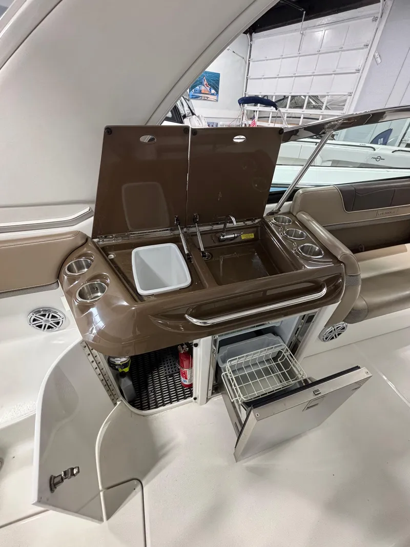 Slide: The Image of 2019 Formula 350 Crossover Bowrider I/O boat interior with kitchenette and storage. - 10