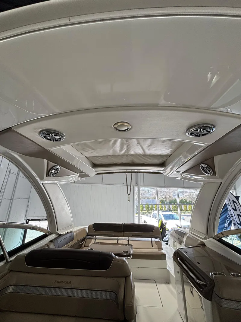 Slide: The Image of 2019 Formula 350 Crossover Bowrider I/O interior with seating and overhead speakers. - 12