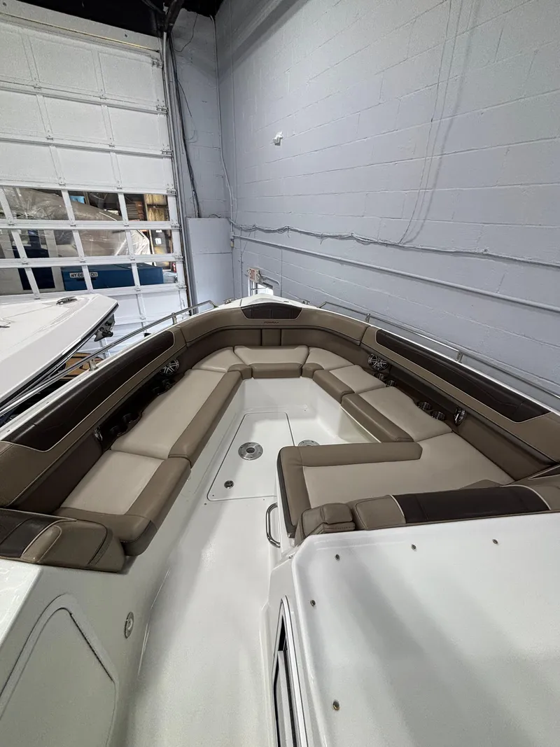 Slide: The Image of 2019 Formula 350 Crossover Bowrider I/O with spacious seating in a showroom. - 14