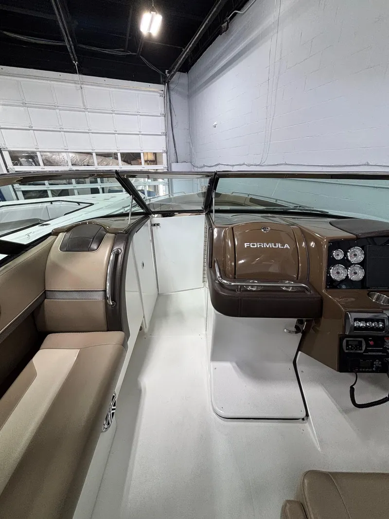 Slide: The Image of 2019 Formula 350 Crossover Bowrider I/O interior with sleek dashboard and seating. - 17
