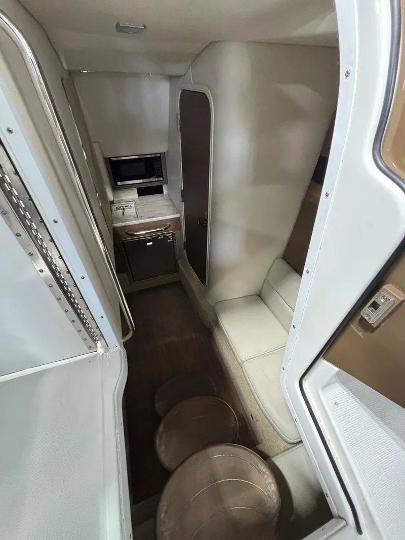 Slide: The Image of 2019 Formula 350 Crossover Bowrider I/O interior with seating and compact kitchenette. - 19