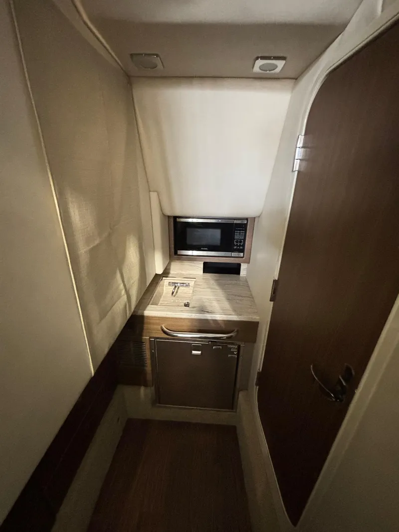 Slide: The Image of 2019 Formula 350 Crossover Bowrider I/O cabin with microwave and compact kitchenette. - 20