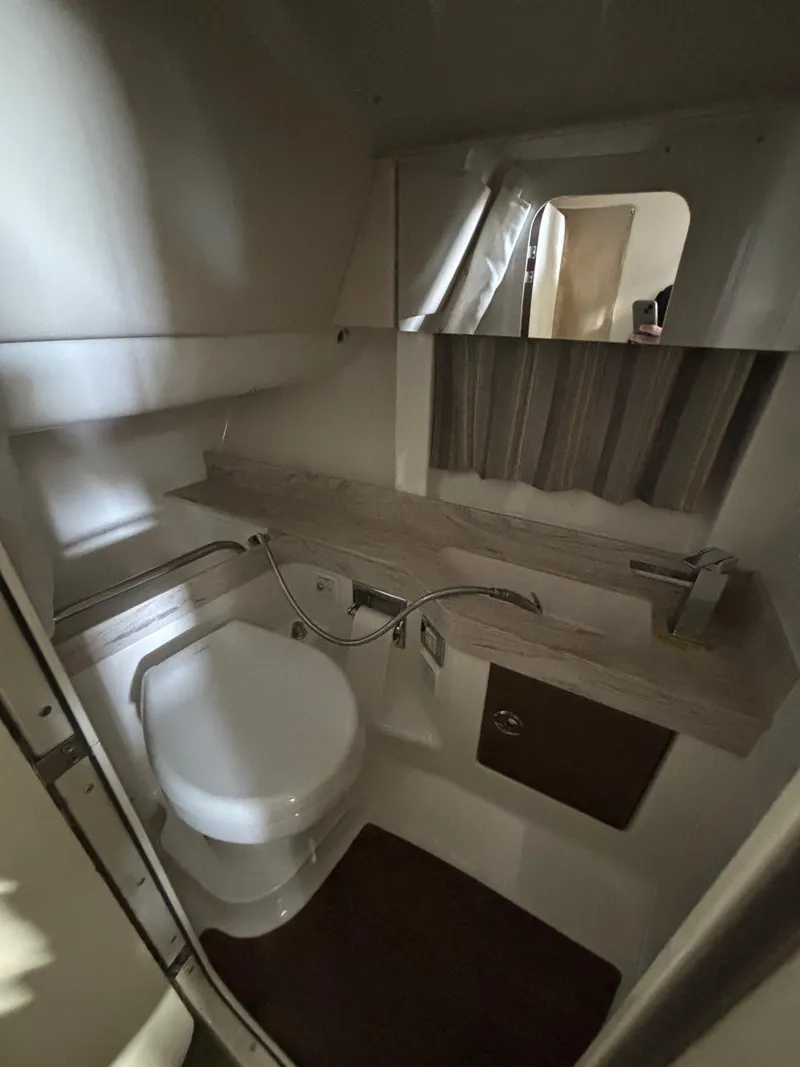 Slide: The Image of 2019 Formula 350 Crossover Bowrider I/O bathroom with modern fixtures and compact design. - 21