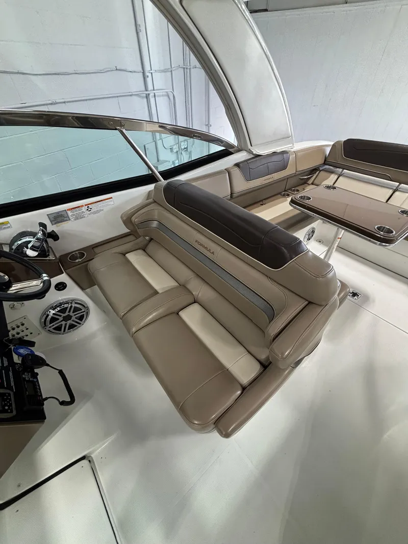 Slide: The Image of 2019 Formula 350 Crossover Bowrider I/O interior with beige seating and modern controls. - 5