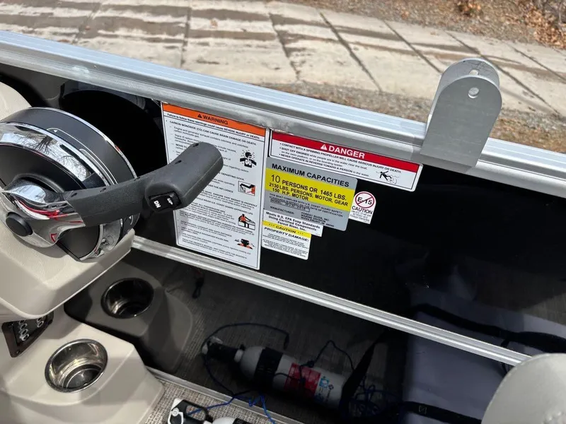 Slide: The Image of Control panel of 2021 South Bay 200 Series S222CR boat with warning labels and capacity information. - 10