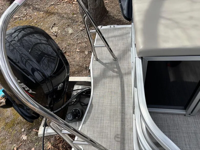 Slide: The Image of 2021 South Bay 200 Series S222CR pontoon boat with Mercury outboard motor and seating area. - 12