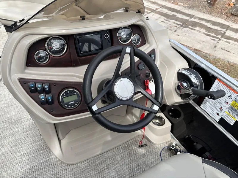 Slide: The Image of Steering console of 2021 South Bay 200 Series S222CR boat with gauges and controls. - 13