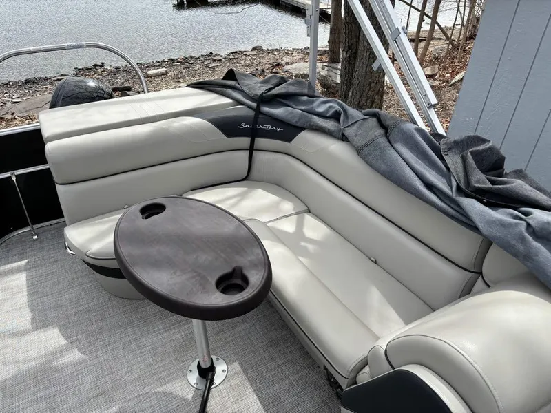 Slide: The Image of Luxurious seating on 2021 South Bay 200 Series S222CR pontoon boat by the water. - 14