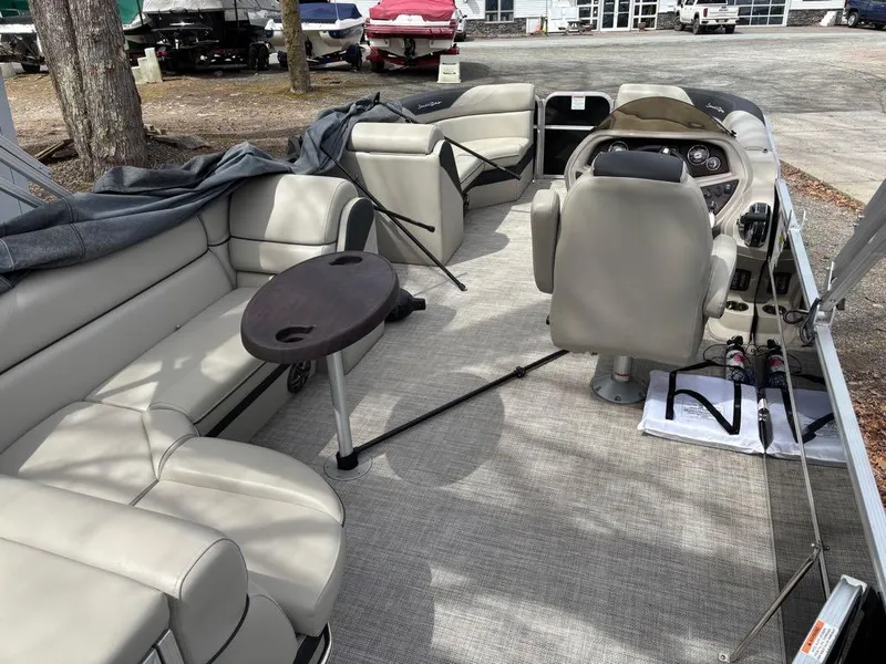 Slide: The Image of 2021 South Bay 200 Series S222CR pontoon boat interior with seating and steering console. - 3