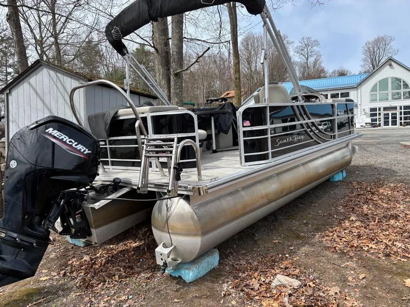 Slide: The Image of 2021 South Bay 200 Series S222CR pontoon boat with Mercury engine, parked outdoors. - 9