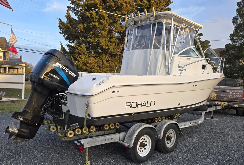 Slide: The Image of 2004 Robalo R235 Walkaround boat on trailer with Mercury outboard engine. - 10