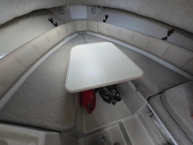Slide: The Image of 2004 Robalo R235 Walkaround cabin interior with table and seating. - 2