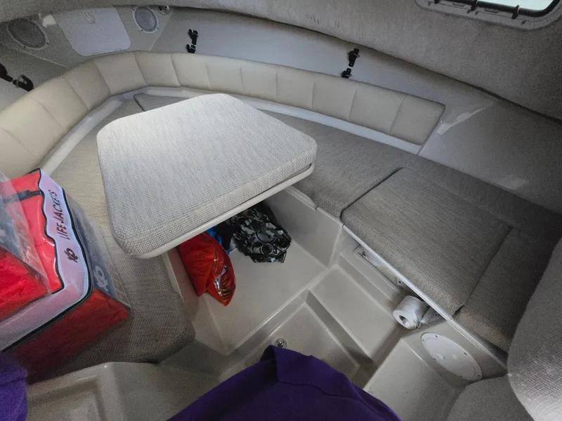 Slide: The Image of 2004 Robalo R235 Walkaround cabin interior with seating and table. - 21