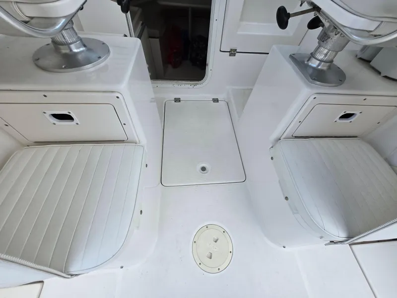 Slide: The Image of 2004 Robalo R235 Walkaround boat interior with seating and storage compartments. - 24