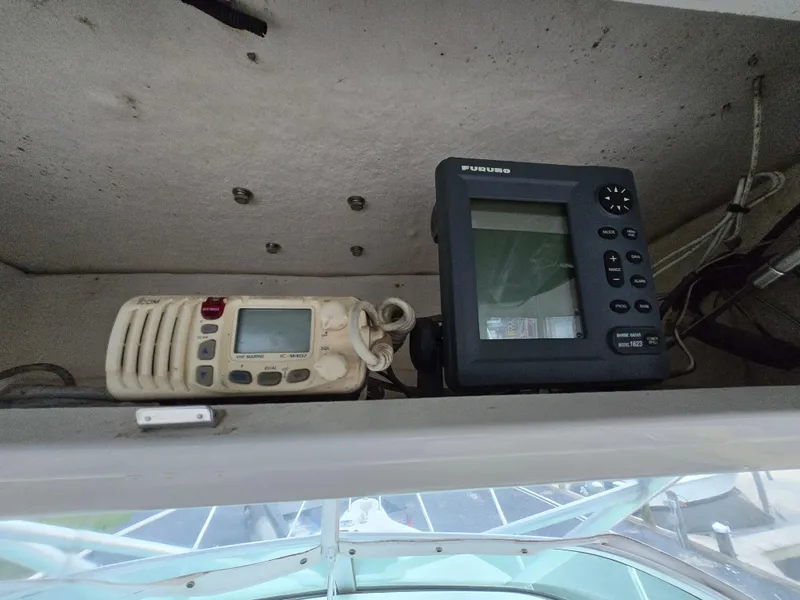 Slide: The Image of 2004 Robalo R235 Walkaround boat electronics, featuring a radio and Furuno navigation system. - 26