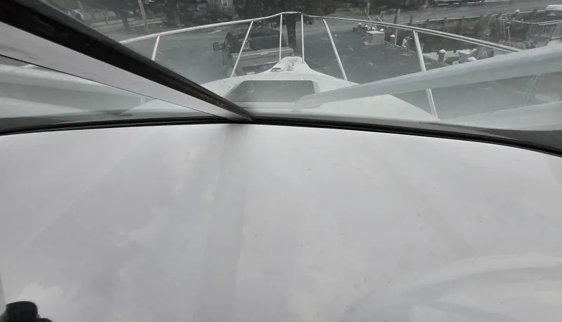 Slide: The Image of 2004 Robalo R235 Walkaround boat view from cockpit, showcasing bow and railing. - 27