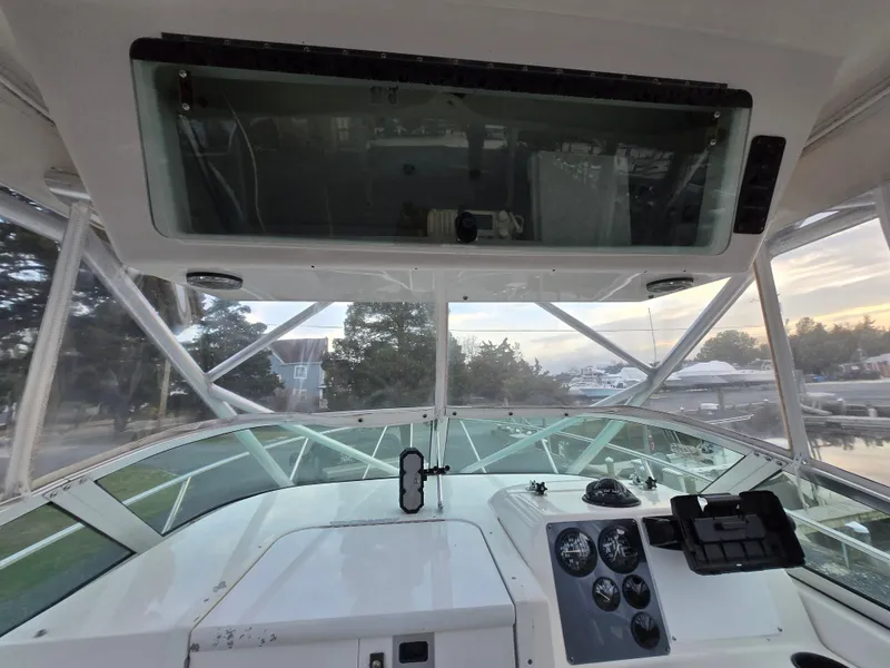 Slide: The Image of 2004 Robalo R235 Walkaround boat cockpit with dashboard and windshield view. - 28