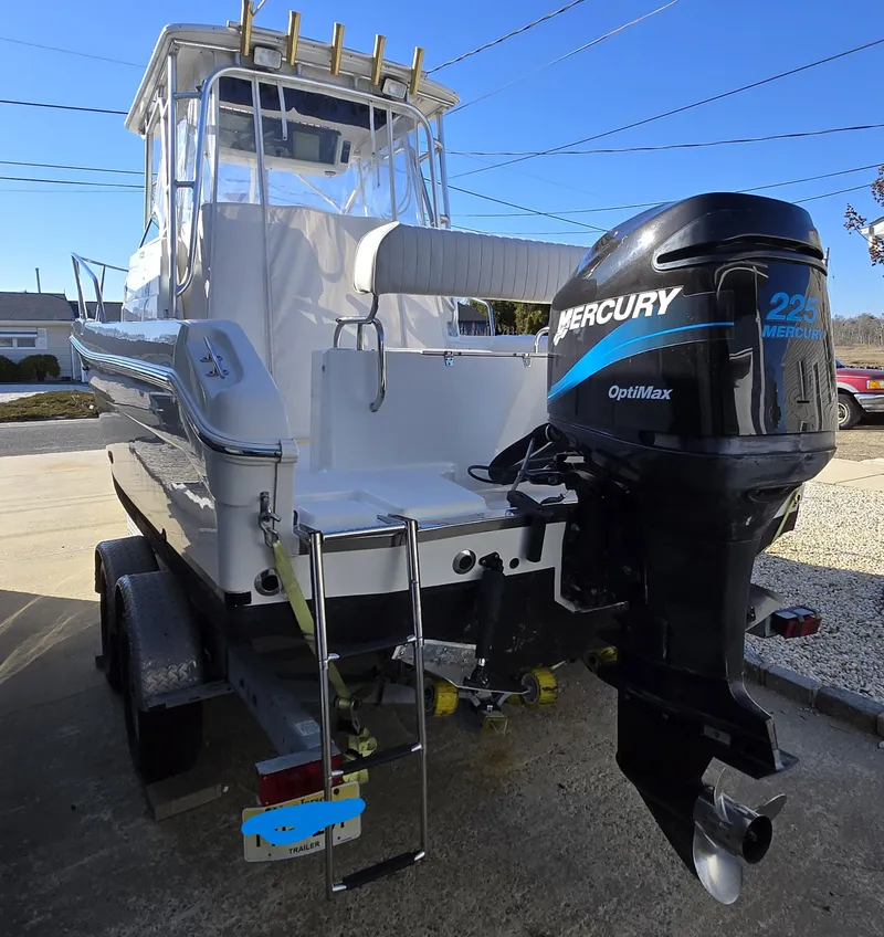 Slide: The Image of 2004 Robalo R235 Walkaround boat with Mercury OptiMax engine on trailer. - 30