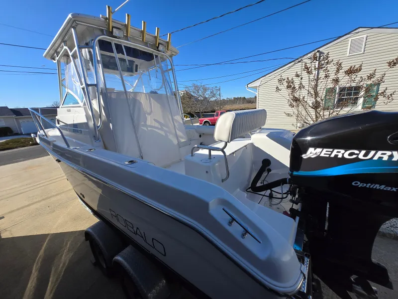 Slide: The Image of 2004 Robalo R235 Walkaround boat with Mercury OptiMax engine, parked on a trailer. - 5