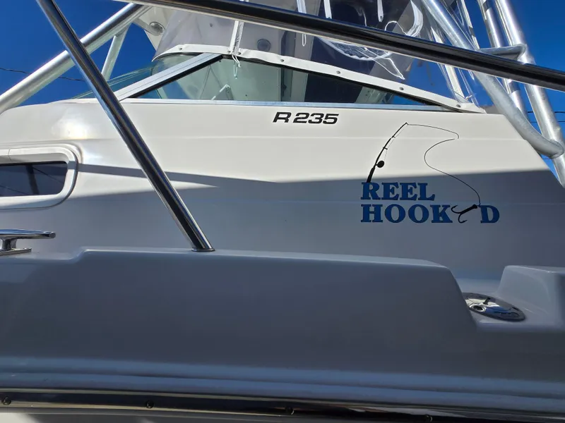 Slide: The Image of 2004 Robalo R235 Walkaround boat with "Reel Hooked" decal on the side. - 6