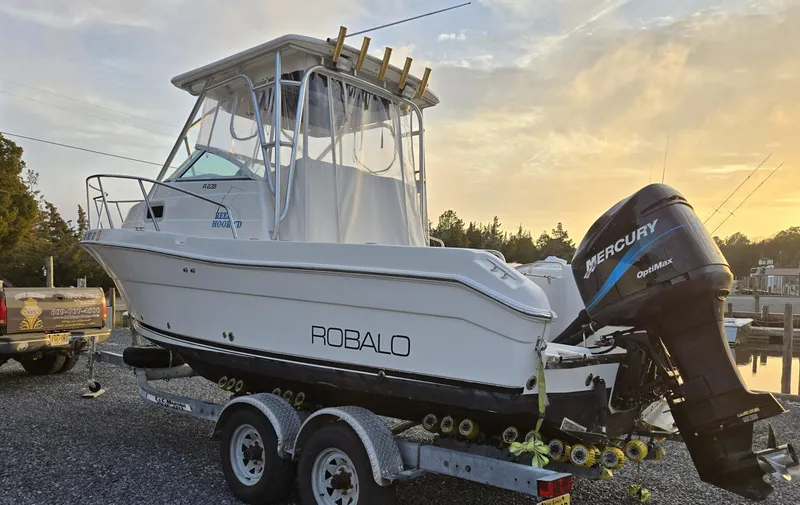 Slide: The Image of 2004 Robalo R235 Walkaround boat on trailer with Mercury outboard motor. - 9