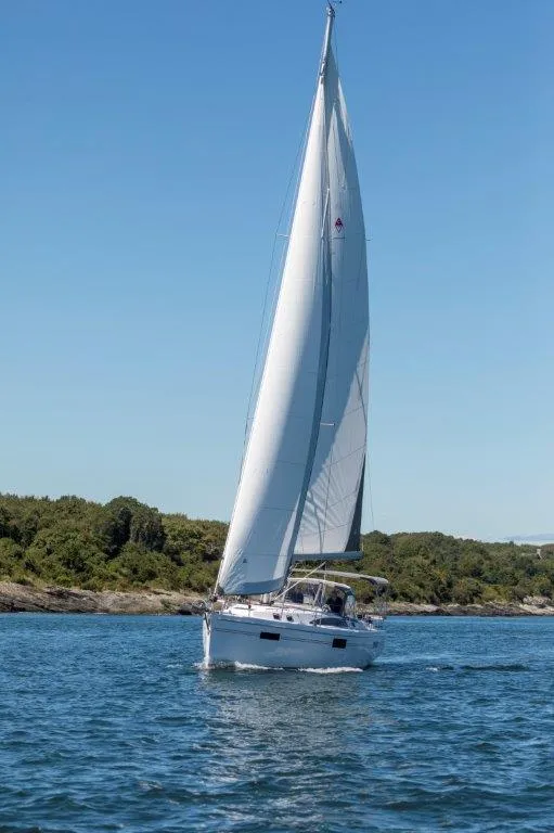 Slide: The Image of Sailing yacht Catalina 426, 2026 model, cruising on a sunny day with lush greenery in the background. - 7