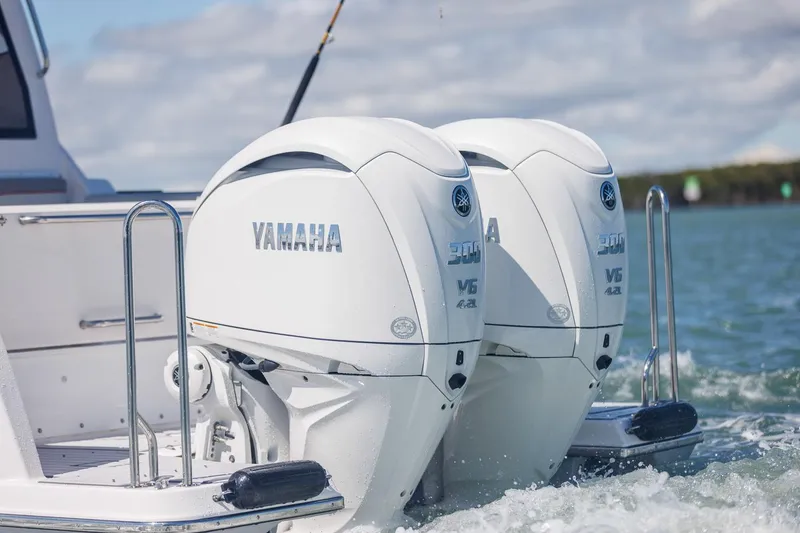 Slide: The Image of Twin Yamaha outboard engines on Solara S-310 SB boat, 2026 model, in water. - 12