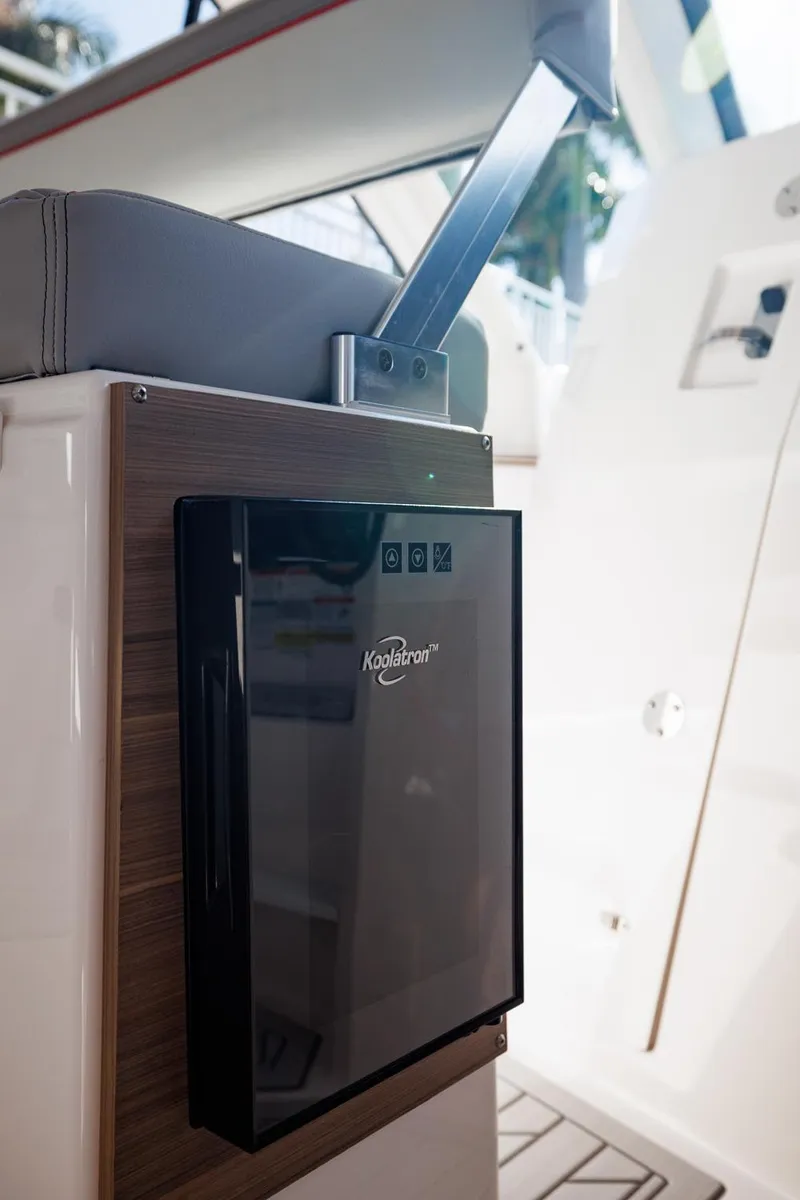 Slide: The Image of Solara S-310 SB 2026 boat interior with Koolatron cooler and seating. - 29