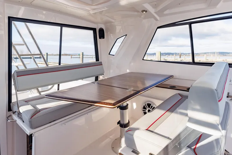 Slide: The Image of Interior of 2026 Solara S-310 SB boat with modern seating and table. - 33