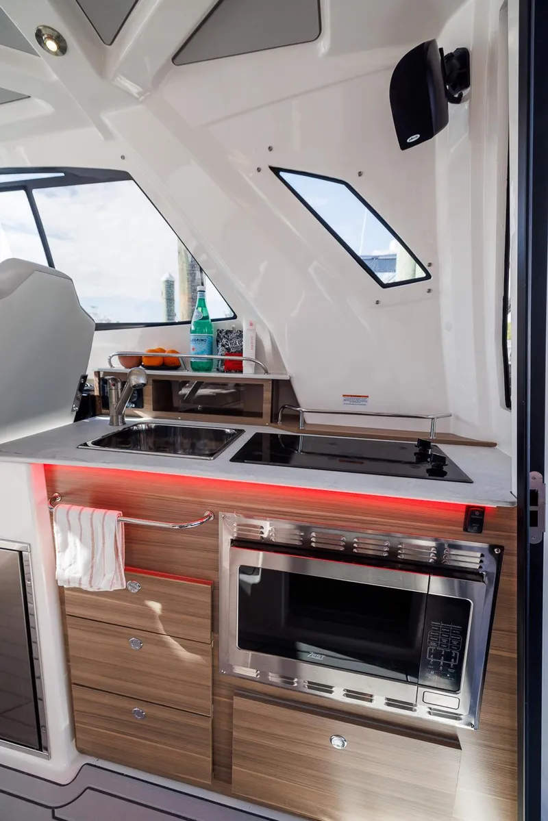 Slide: The Image of Modern kitchen area in 2026 Solara S-310 SB boat with sleek appliances and wood cabinetry. - 37