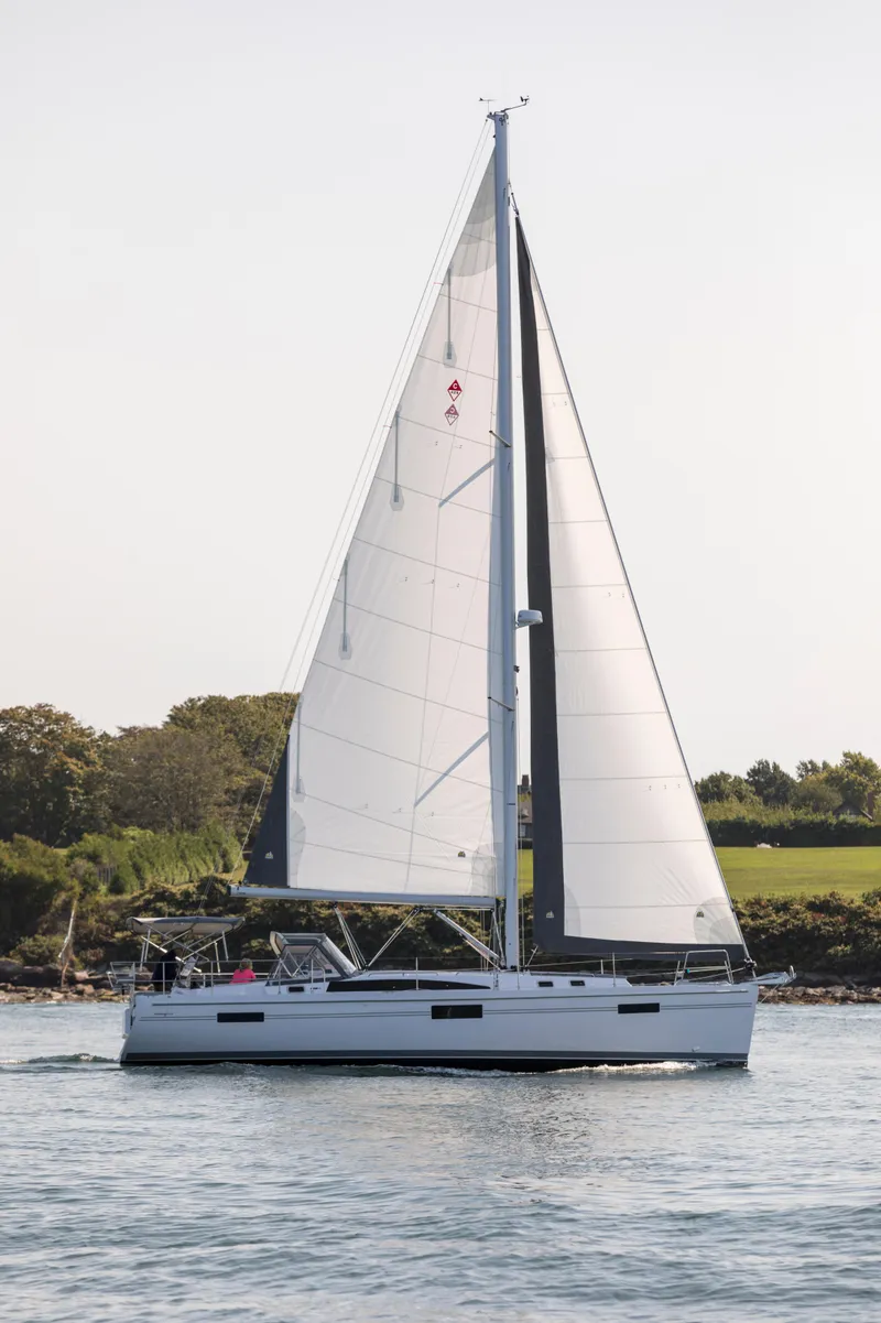 Slide: The Image of Sailing yacht Catalina 426, 2026 model, cruising on calm waters near a green shoreline. - 4