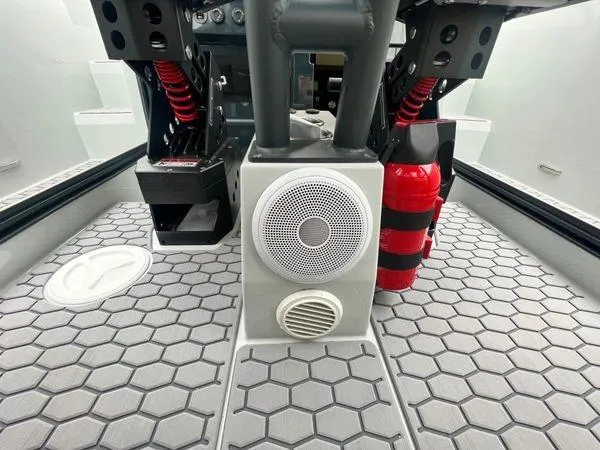 Slide: The Image of 2024 XO Boats DFNDR 9 interior with hexagonal flooring, speaker, and fire extinguisher. - 12