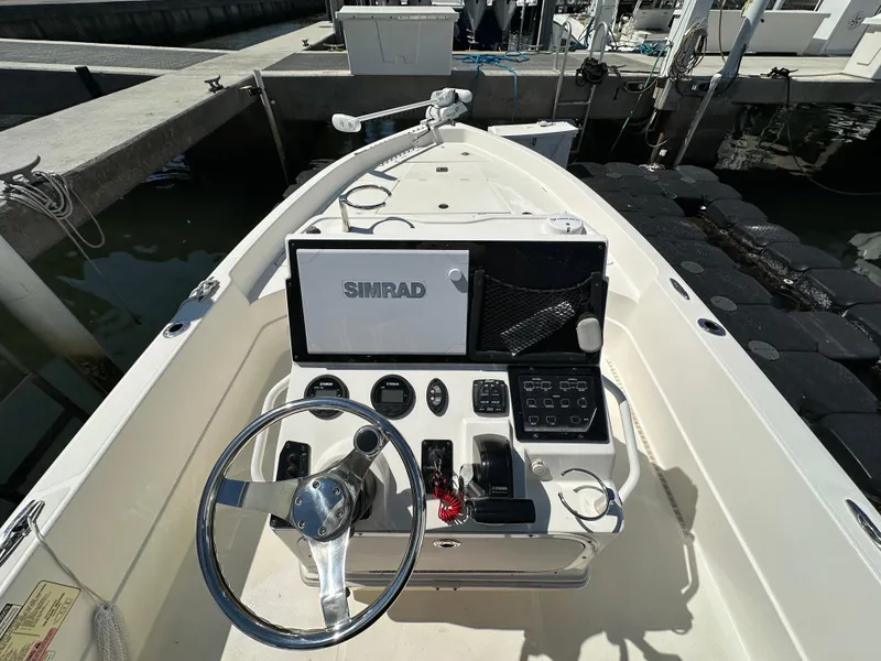 Slide: The Image of 2021 Skeeter SX 2250 boat dashboard with steering wheel and Simrad navigation system. - 3