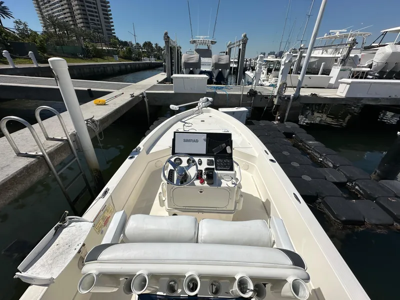 Slide: The Image of 2021 Skeeter SX 2250 boat docked at marina, featuring modern console and seating. - 4