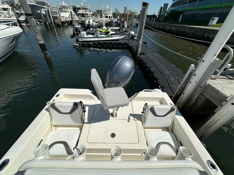 Slide: The Image of 2021 Skeeter SX 2250 boat docked at marina, featuring seating and motor. - 5