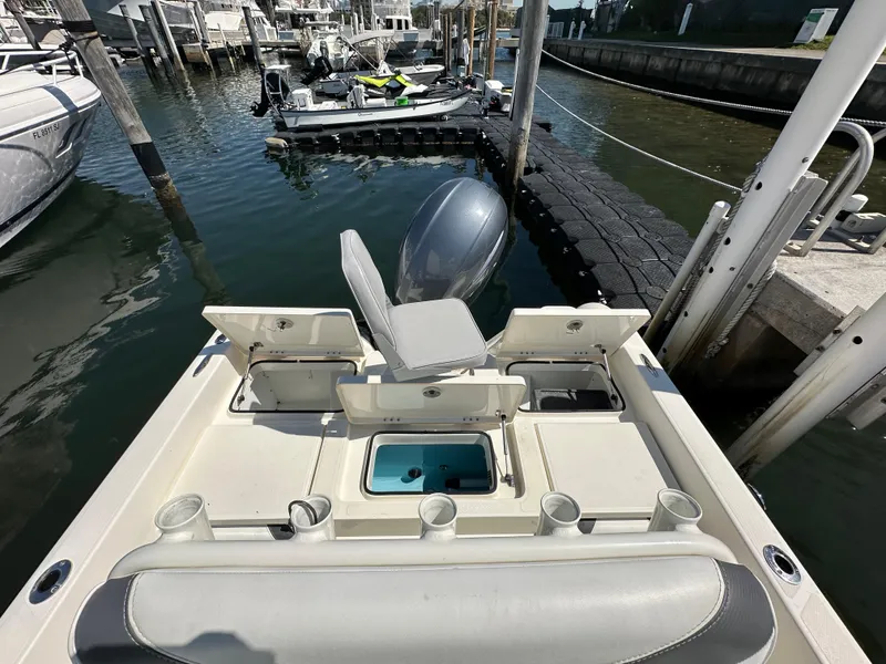 Slide: The Image of 2021 Skeeter SX 2250 boat docked, featuring seating and storage compartments. - 6