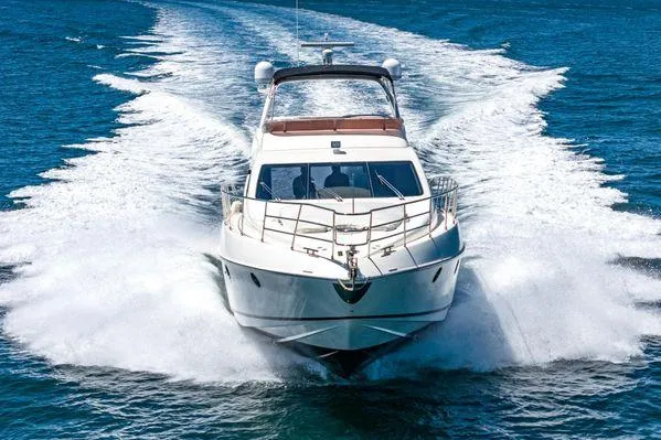 Slide: The Image of 2007 Azimut 62 yacht cruising on open water, creating a dynamic wake. - 11