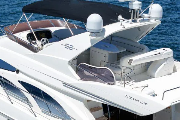 Slide: The Image of 2007 Azimut 62 yacht with sleek design and spacious deck on blue water. - 12