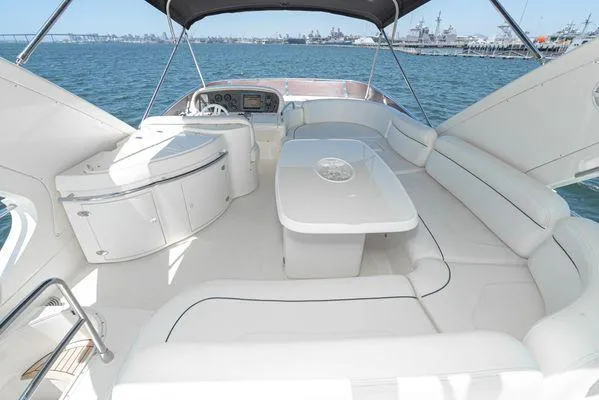Slide: The Image of Luxurious 2007 Azimut 62 yacht interior with elegant seating and table, overlooking serene waters. - 14