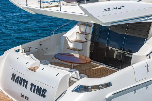 Slide: The Image of 2007 Azimut 62 yacht with elegant deck and seating area on the water. - 2