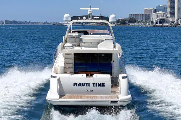 Slide: The Image of Azimut 62 yacht cruising on open water, city skyline in background, 2007 model. - 20