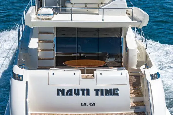 Slide: The Image of Azimut 62 yacht from 2007, named "Nauti Time," cruising in open water. - 21