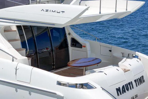 Slide: The Image of Luxury 2007 Azimut 62 yacht with sleek design, docked by the water. - 22