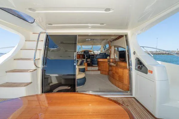 Slide: The Image of Luxurious 2007 Azimut 62 yacht interior with elegant wood finishes and spacious seating area. - 23