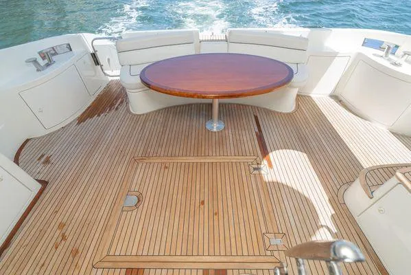 Slide: The Image of Luxurious 2007 Azimut 62 yacht deck with wooden flooring and round table. - 24