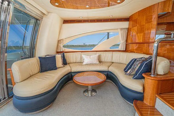 Slide: The Image of Luxurious 2007 Azimut 62 yacht interior with elegant curved seating and stylish wooden accents. - 26