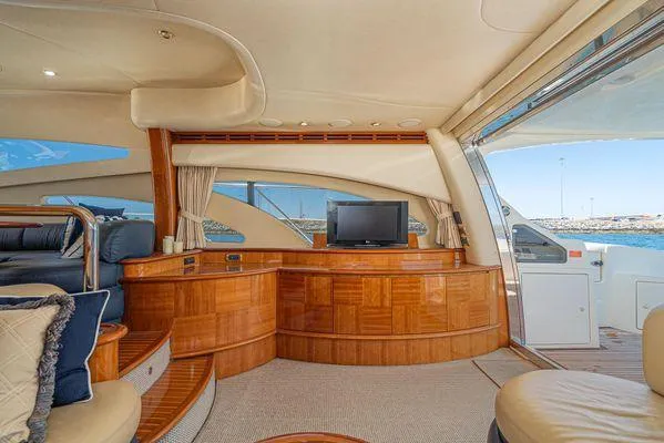 Slide: The Image of Luxurious interior of a 2007 Azimut 62 yacht with elegant wood finishes and a scenic view. - 28