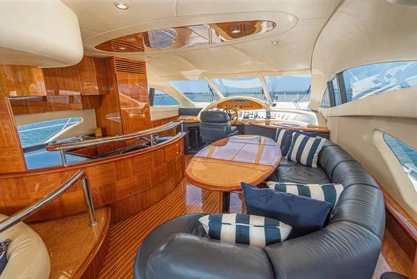 Slide: The Image of Luxurious interior of a 2007 Azimut 62 yacht with elegant wood finishes and plush seating. - 30