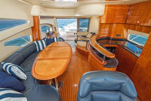 Slide: The Image of Luxurious 2007 Azimut 62 yacht interior with elegant wood finishes and plush seating. - 31