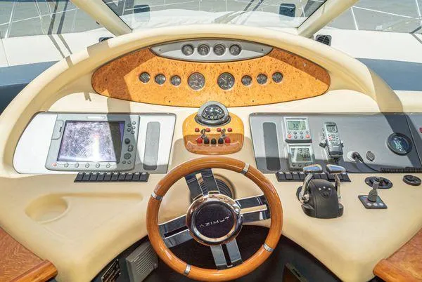 Slide: The Image of Cockpit of 2007 Azimut 62 yacht with navigation instruments and wooden steering wheel. - 36